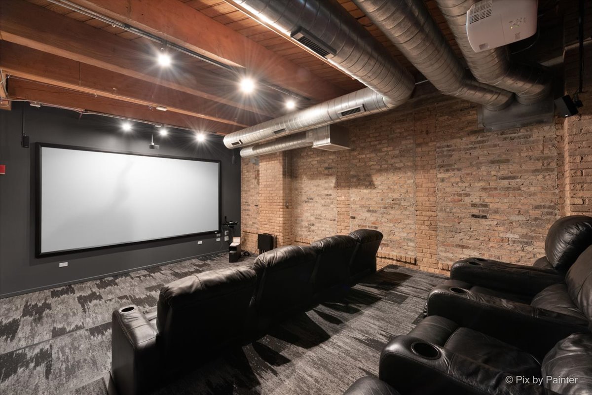 1040 West Adams Street, Unit 459 Chicago, IL 60607 - Photo 26 of 30 a projector room with a projector and couches