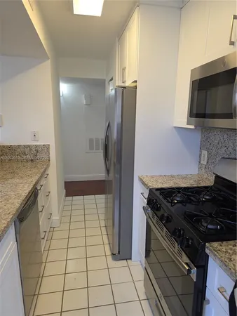 a kitchen with a sink and a stove top oven