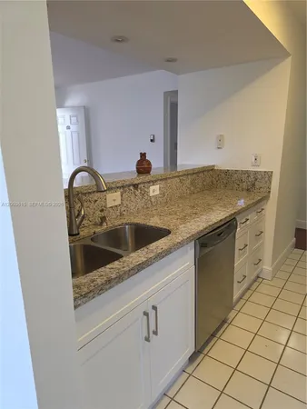 a kitchen with stainless steel appliances granite countertop a stove a microwave and a refrigerator