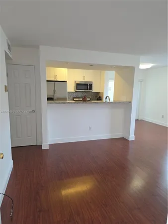 a view of kitchen and wooden floor