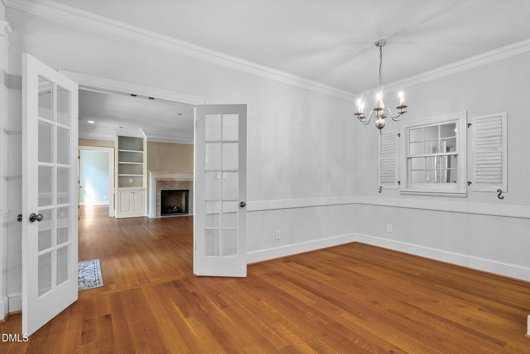 1505 Chester Road Raleigh, NC 27608 - Photo 22 of 80 a view of a room with wooden floor and chandelier