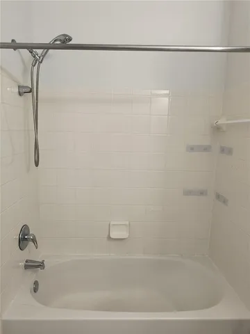 a bathroom with a shower and a bath tub
