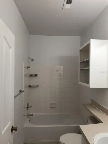 a bathroom with a sink toilet and mirror