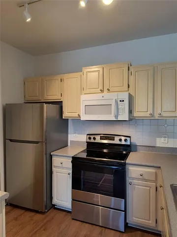 a kitchen with a stove and a refrigerator