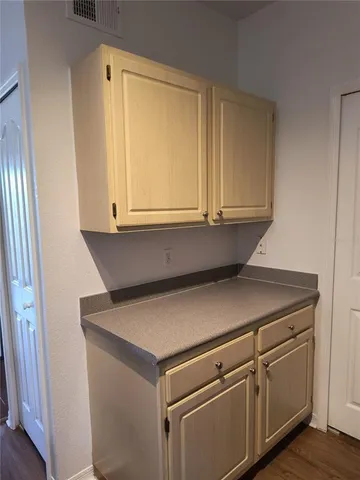 a view of cabinets and wooden floor