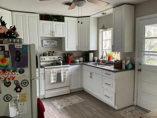 a kitchen with stainless steel appliances a refrigerator sink and cabinets
