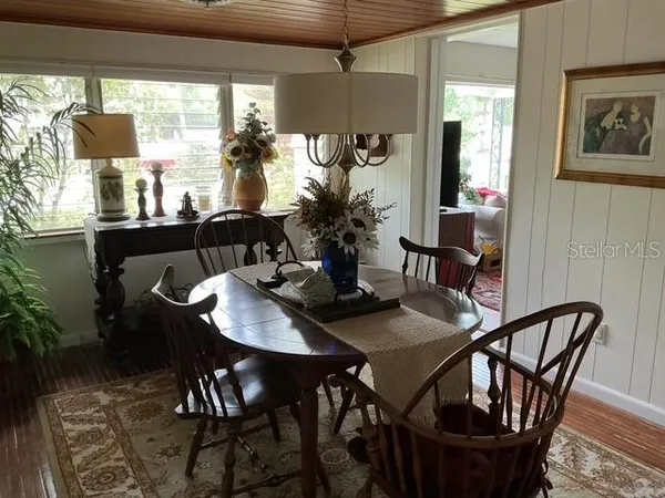 a view of a dining room with furniture and window