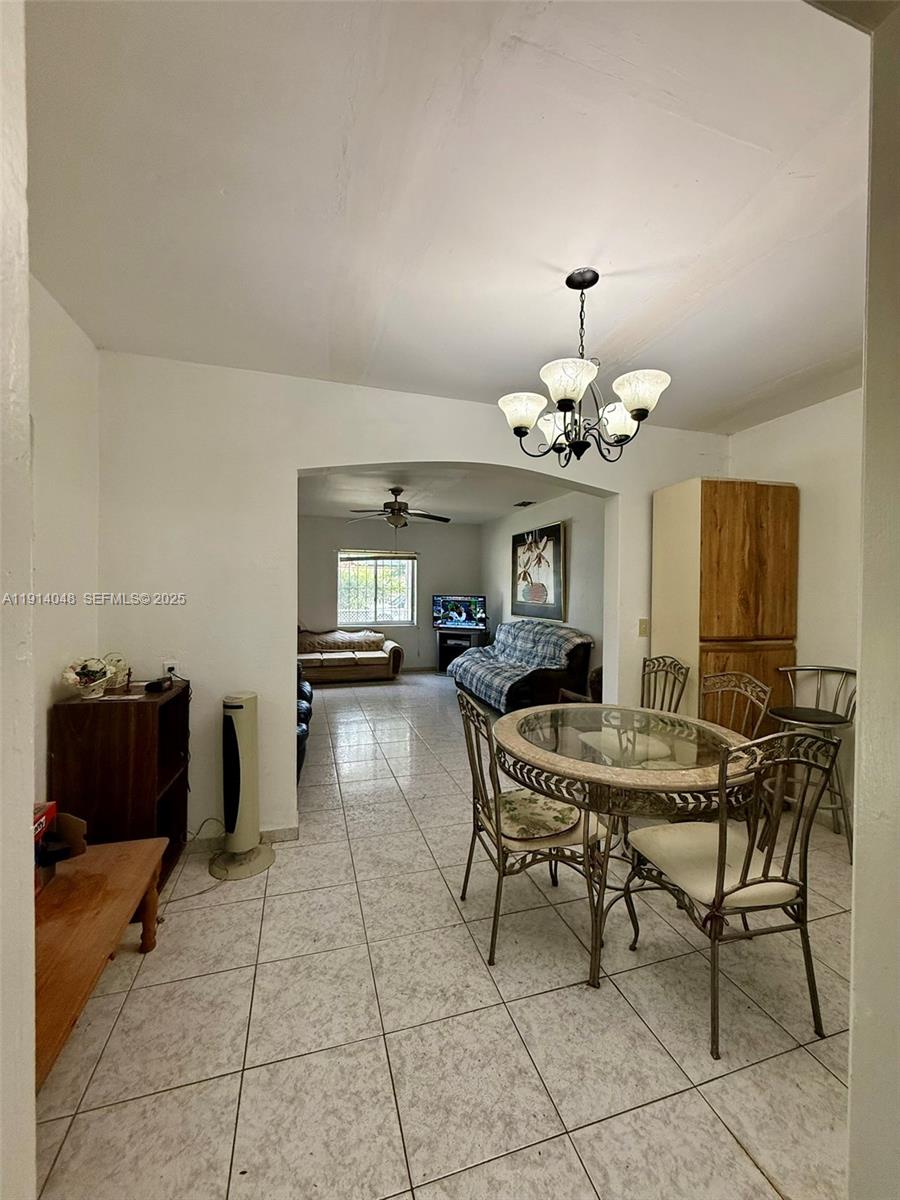 3000 Northwest 5th Street Miami, FL 33125 - Photo 12 of 54 a dining room with furniture and chandelier