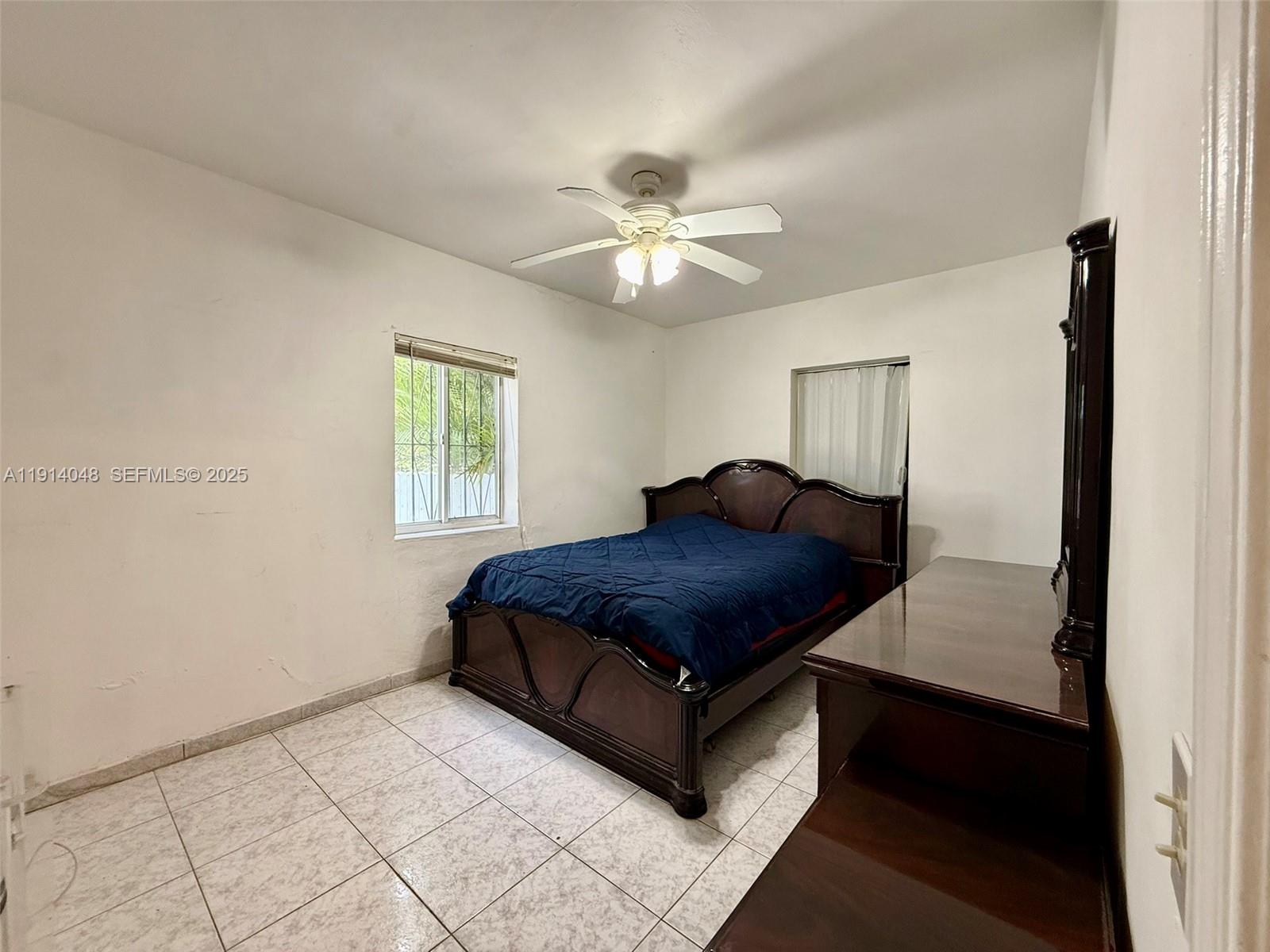 3000 Northwest 5th Street Miami, FL 33125 - Photo 14 of 54 a bedroom with a bed and a chandelier