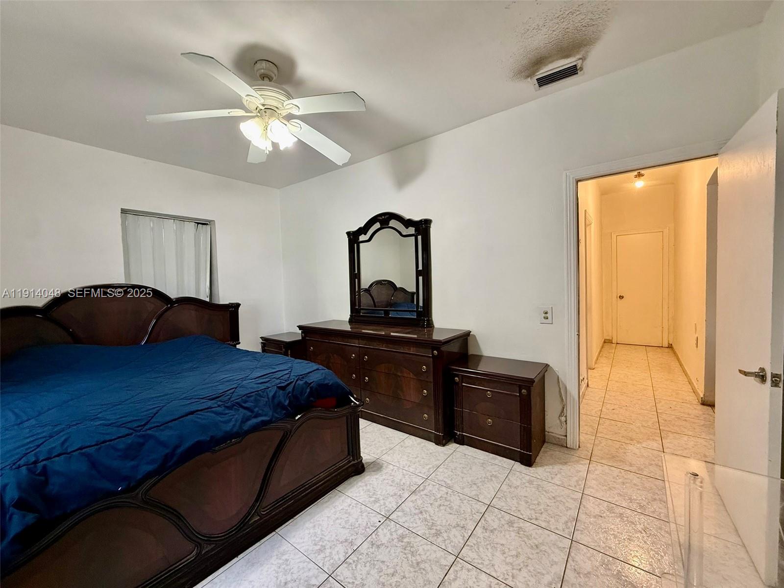 3000 Northwest 5th Street Miami, FL 33125 - Photo 15 of 54 a bedroom with a bed and a chandelier