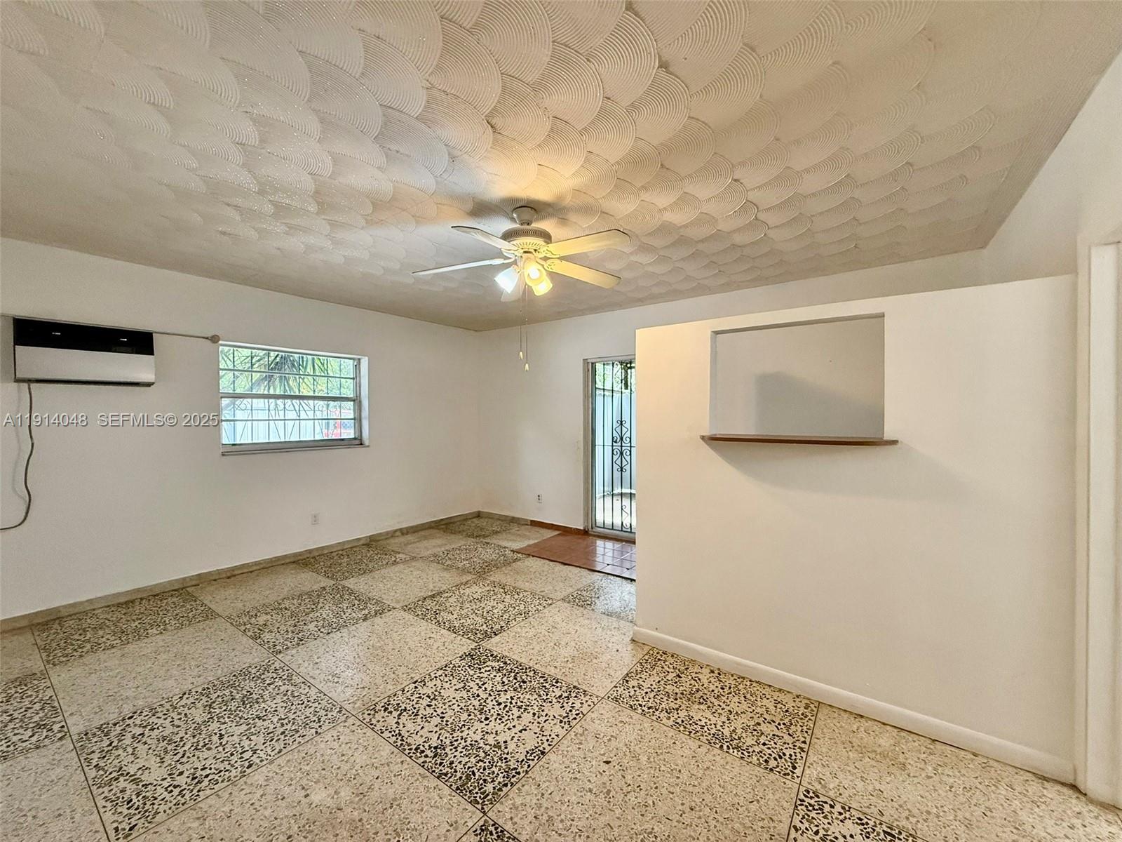 3000 Northwest 5th Street Miami, FL 33125 - Photo 27 of 54 a view of a big room with wooden floor and a ceiling fan