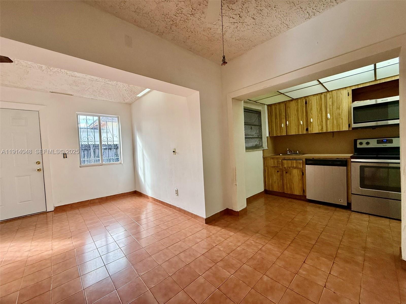 3000 Northwest 5th Street Miami, FL 33125 - Photo 32 of 54 a view of a kitchen with microwave and stove top oven
