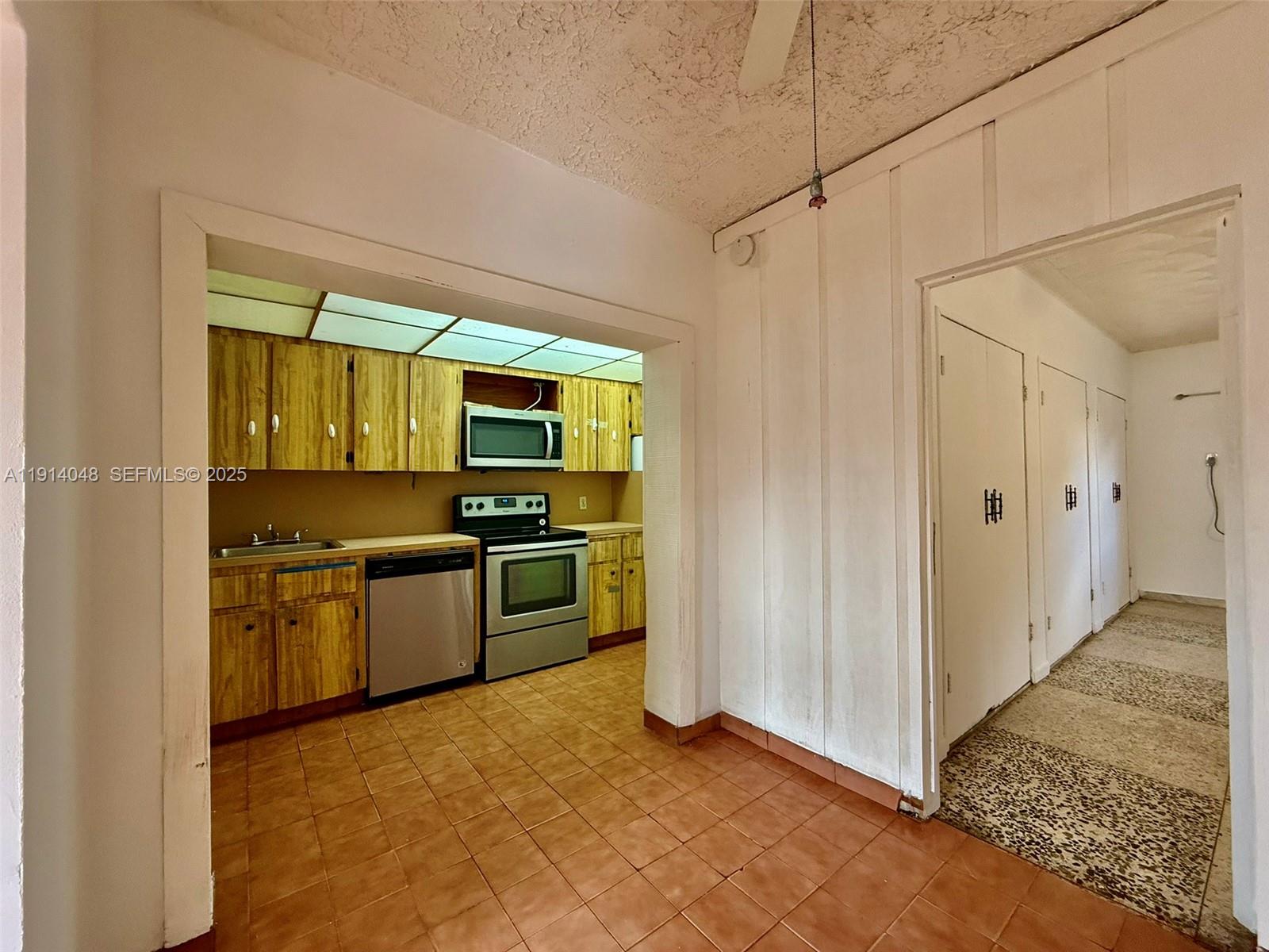 3000 Northwest 5th Street Miami, FL 33125 - Photo 33 of 54 a kitchen with stainless steel appliances a refrigerator and a stove