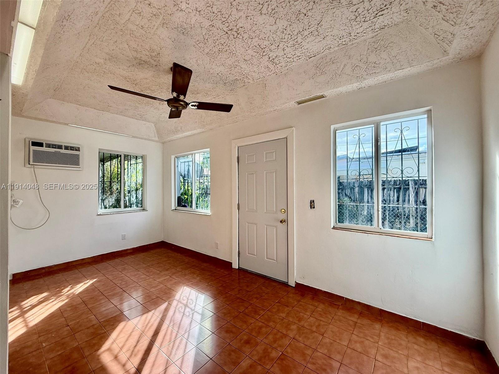 3000 Northwest 5th Street Miami, FL 33125 - Photo 38 of 54 wooden floor in an empty room with a window