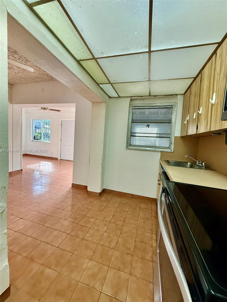 3000 Northwest 5th Street Miami, FL 33125 - Photo 40 of 54 a view of a kitchen with a sink and a stove