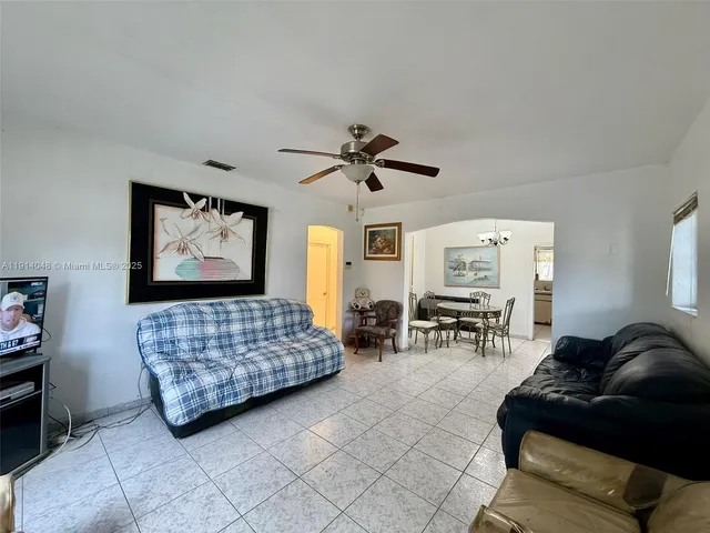a kitchen with a sink window and cabinets