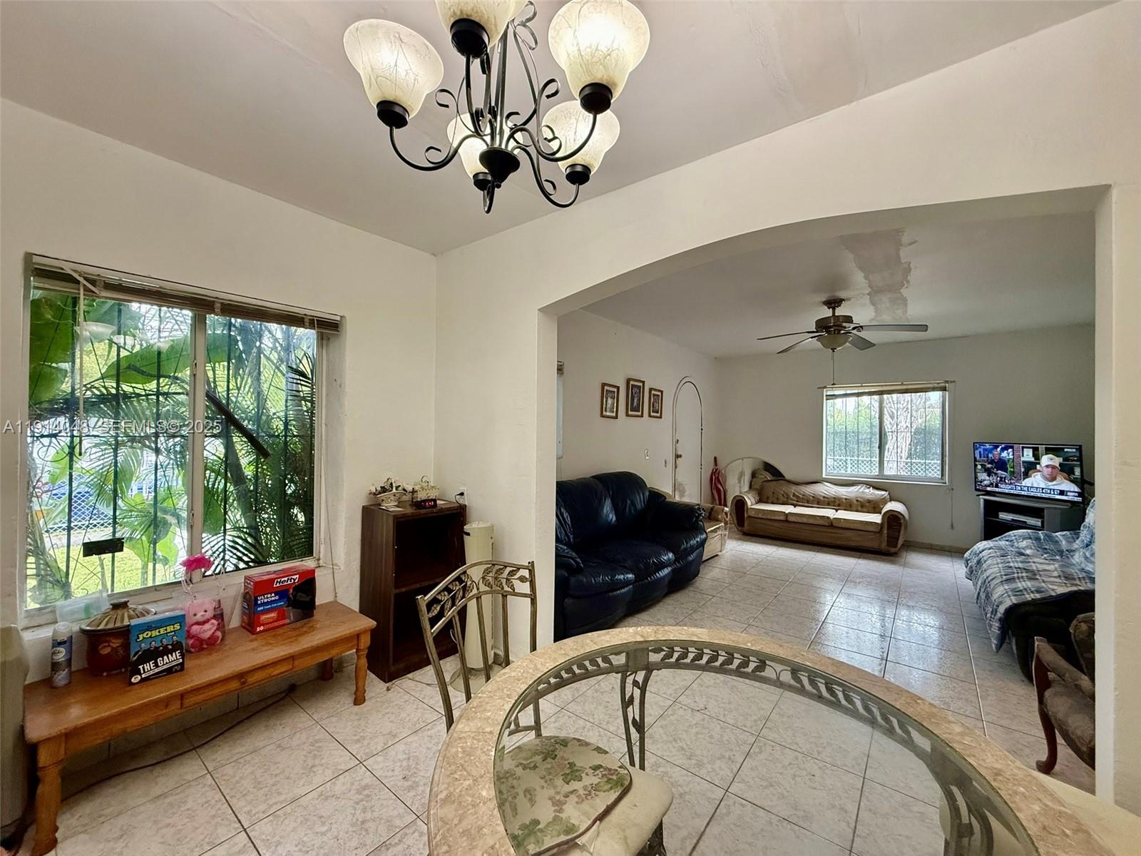 3000 Northwest 5th Street Miami, FL 33125 - Photo 7 of 54 a living room with furniture fireplace and large windows
