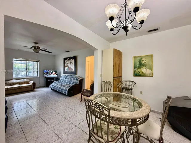 a spacious bedroom with a bed and a flat screen tv