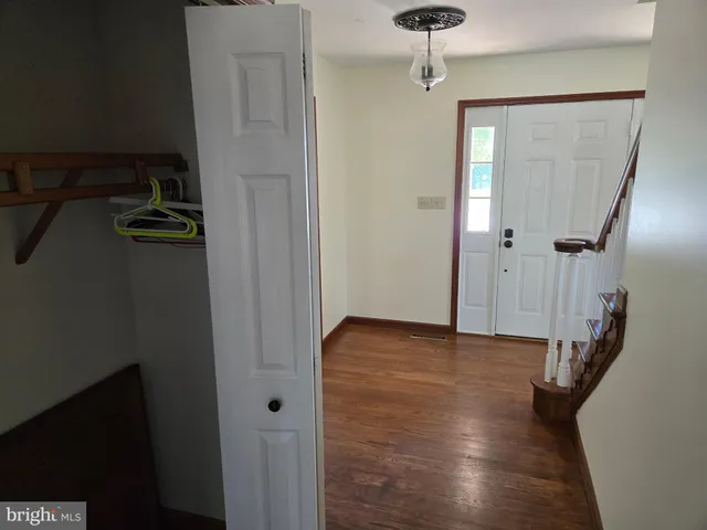 a view of hallway with wooden floor