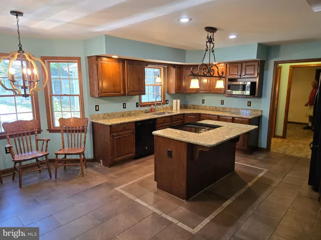 a kitchen with a stove sink and cabinets