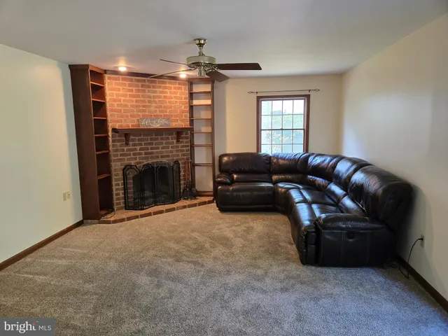 a living room with furniture window and fireplace