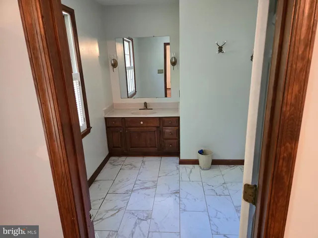 a bathroom with a sink a mirror and a bathtub