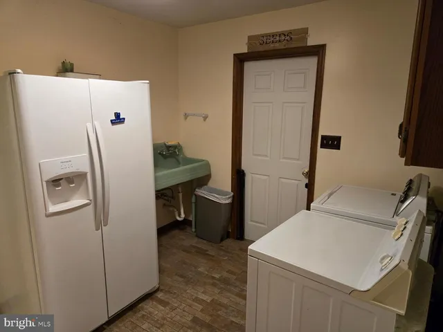 a room with a refrigerator and washer