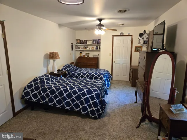 a bedroom with a bed dresser and a window