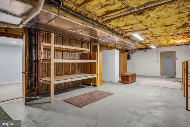 a view of a room with wooden walls and windows