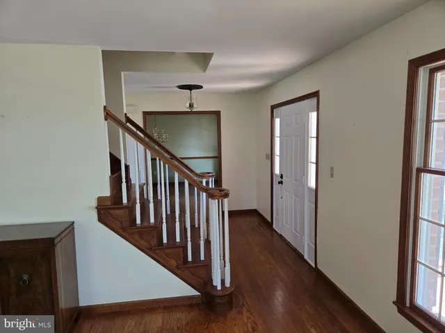 a view of a hallway with the wooden floor and entryway