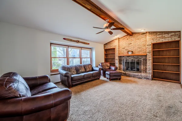 a living room with furniture a fireplace and a flat screen tv