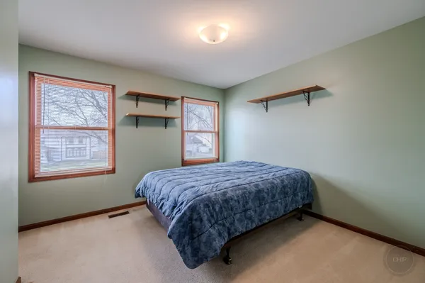 a spacious bedroom with a bed and window