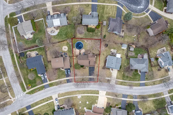 a view of a yard with a house in the background