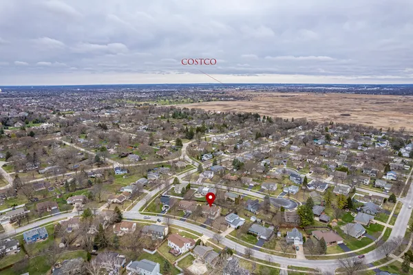 an aerial view of a house with outdoor space and parking