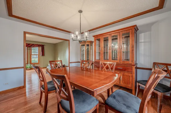 a kitchen with stainless steel appliances granite countertop a refrigerator a sink and wooden cabinets