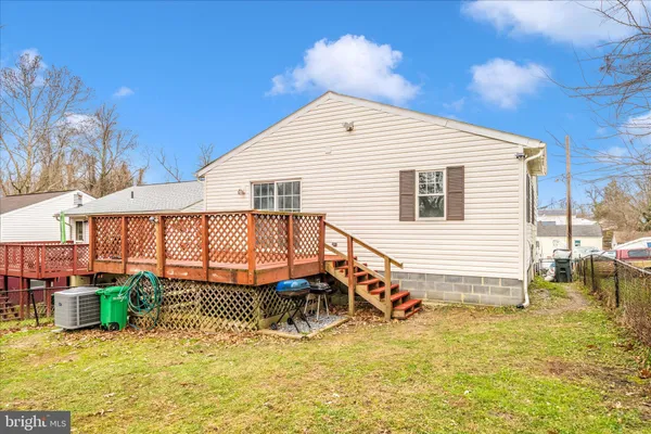 a view of a house with a yard table and chairs