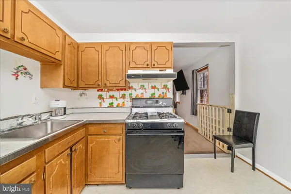 a kitchen that has a sink and a stove