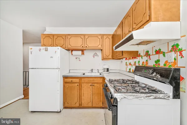 a kitchen with a stove and a refrigerator