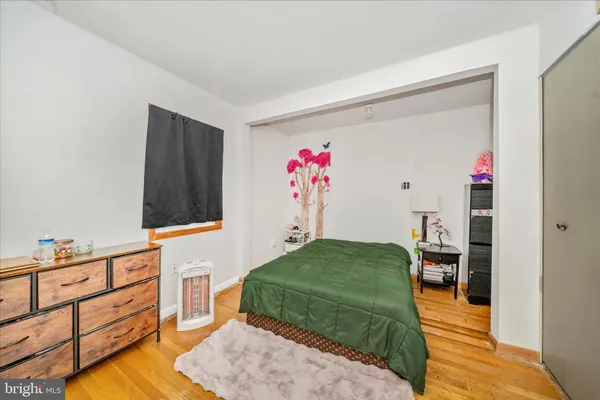 a living room with furniture and a baby crib
