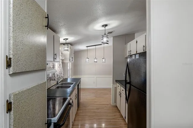a kitchen with stainless steel appliances a refrigerator and cabinets