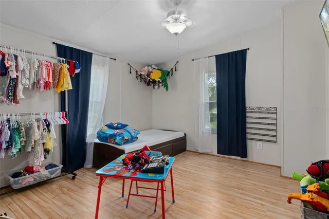 a living room with furniture and a kitchen