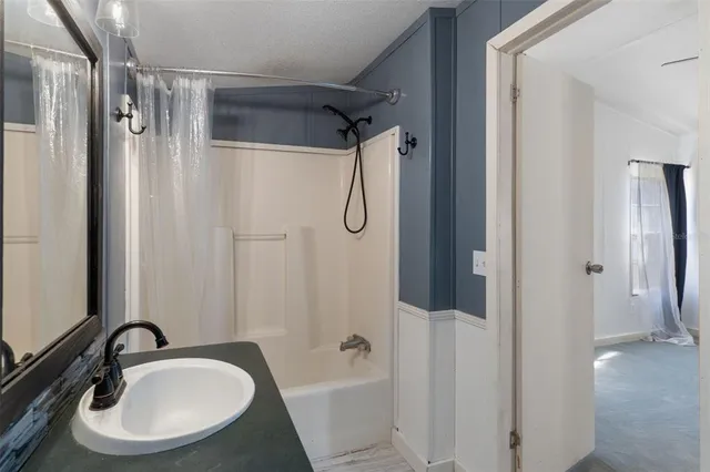 a bathroom with a sink and shower