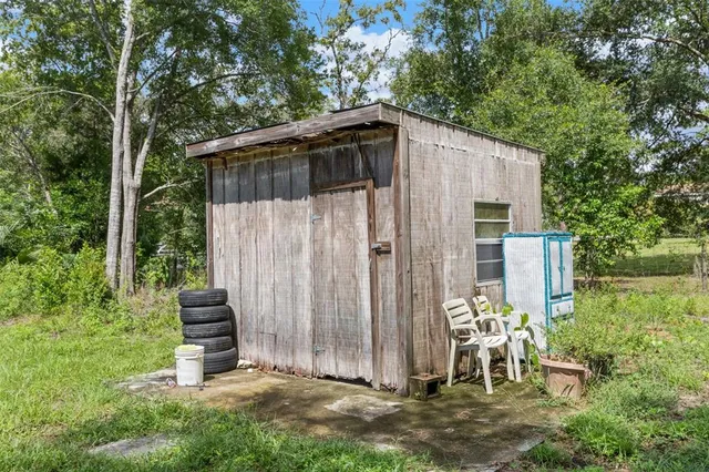 a backyard of a house with table and chairs
