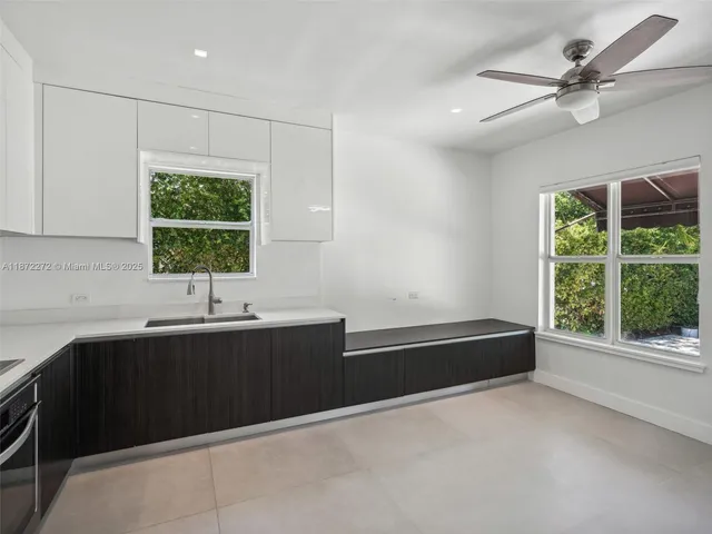 a kitchen with granite countertop a sink and a stove top oven