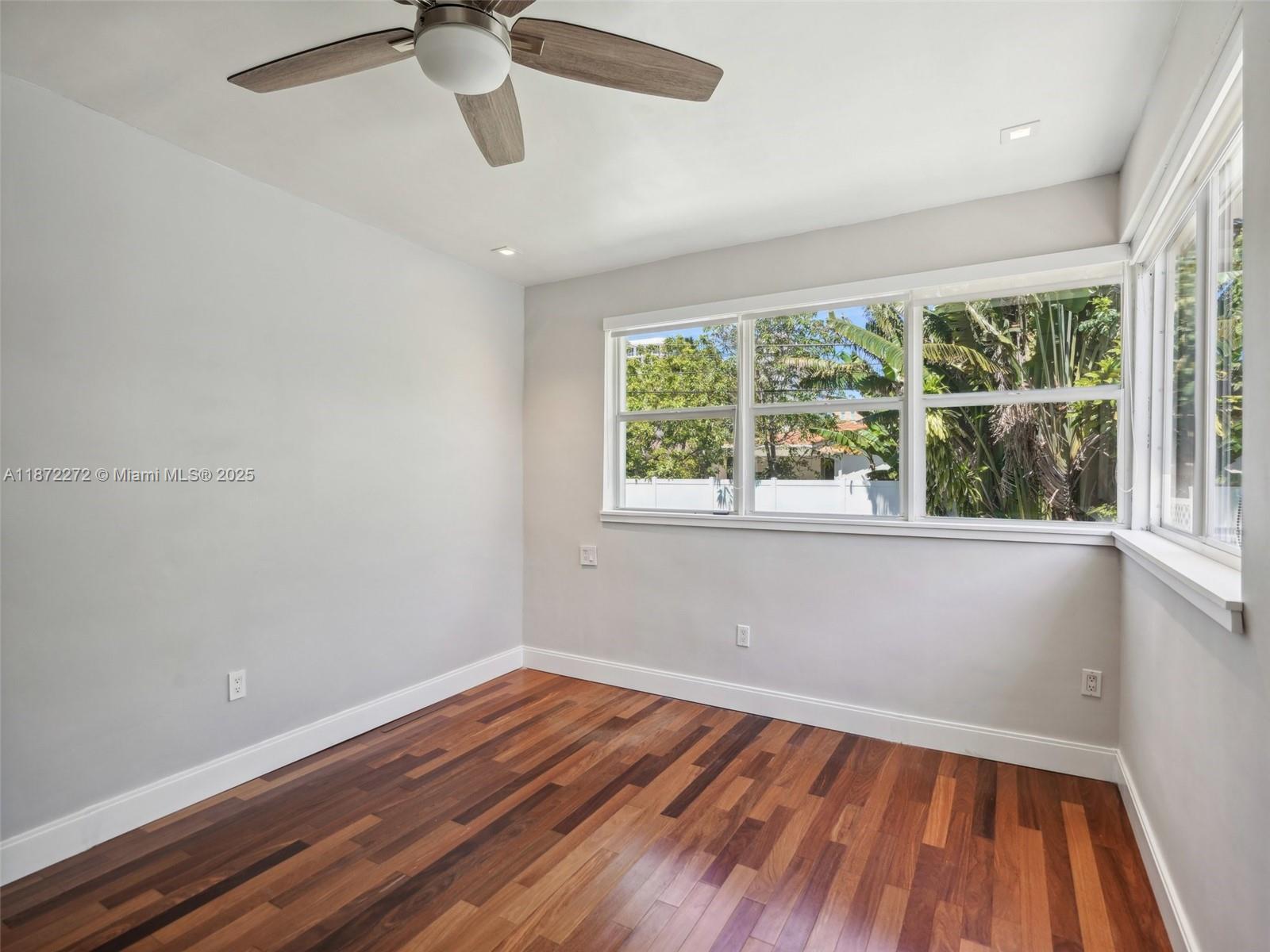8875 Abbott Avenue Surfside, FL 33154 - Photo 26 of 45 wooden floor in an empty room with a window