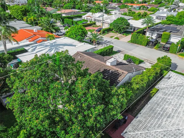 an aerial view of a house with a yard and swimming pool