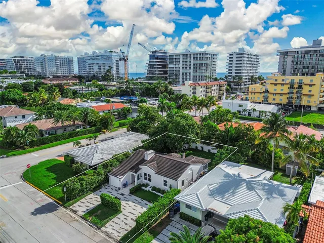 an aerial view of multiple houses with yard