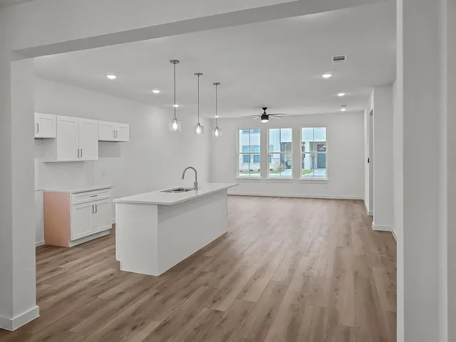 a large kitchen with kitchen island a sink stainless steel appliances and cabinets