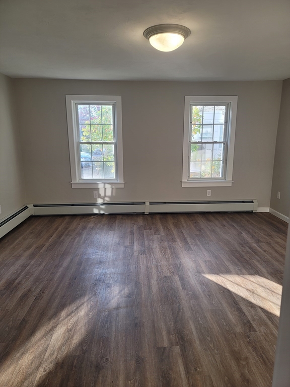45 Main Street, Unit I Charlton, MA 01507 - Photo 3 of 11 an empty room with wooden floor and windows