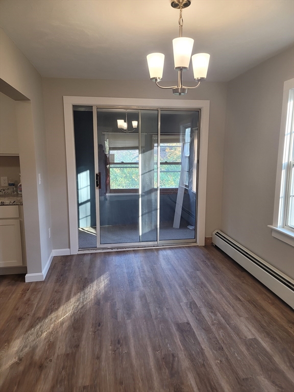 45 Main Street, Unit I Charlton, MA 01507 - Photo 4 of 11 an empty room with wooden floor and windows
